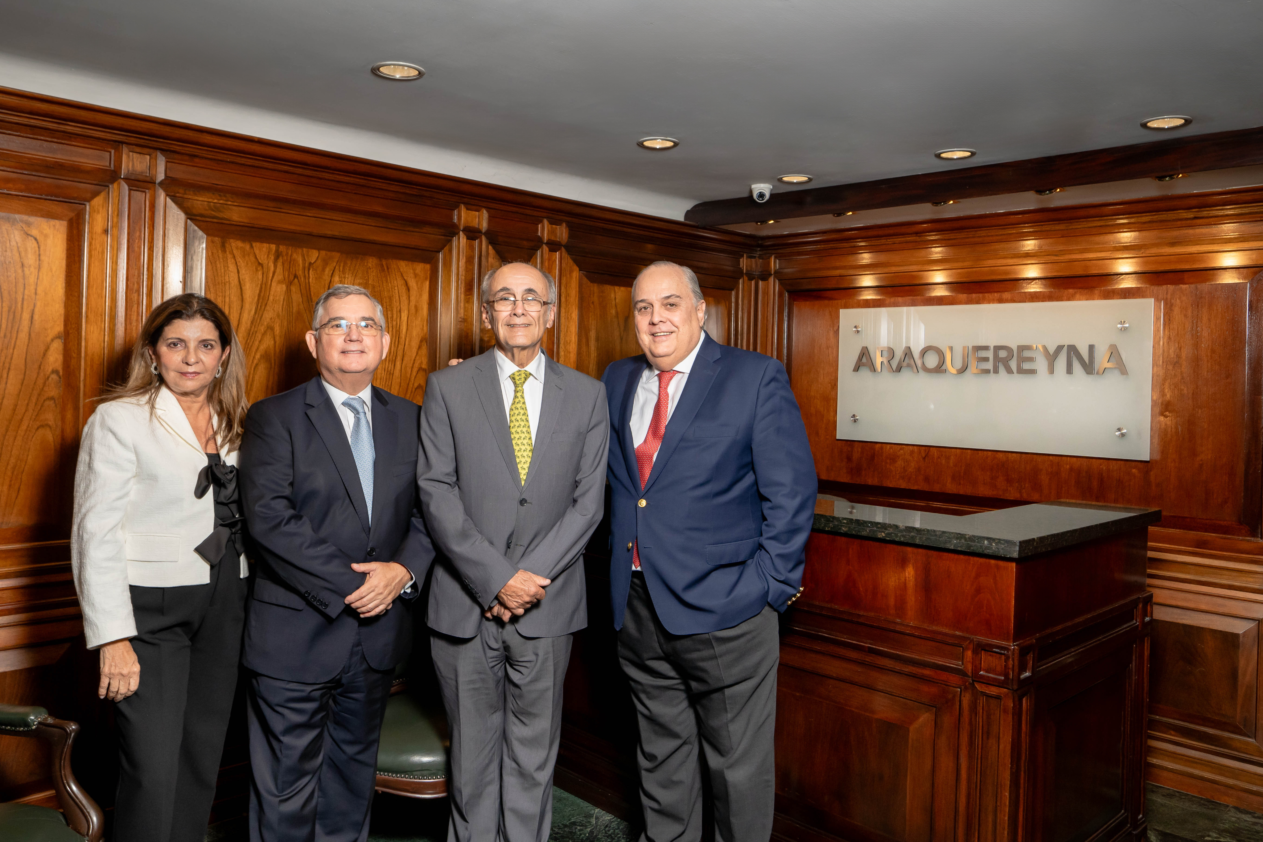 Two women sitting at a modern table talking with a city view behind them.